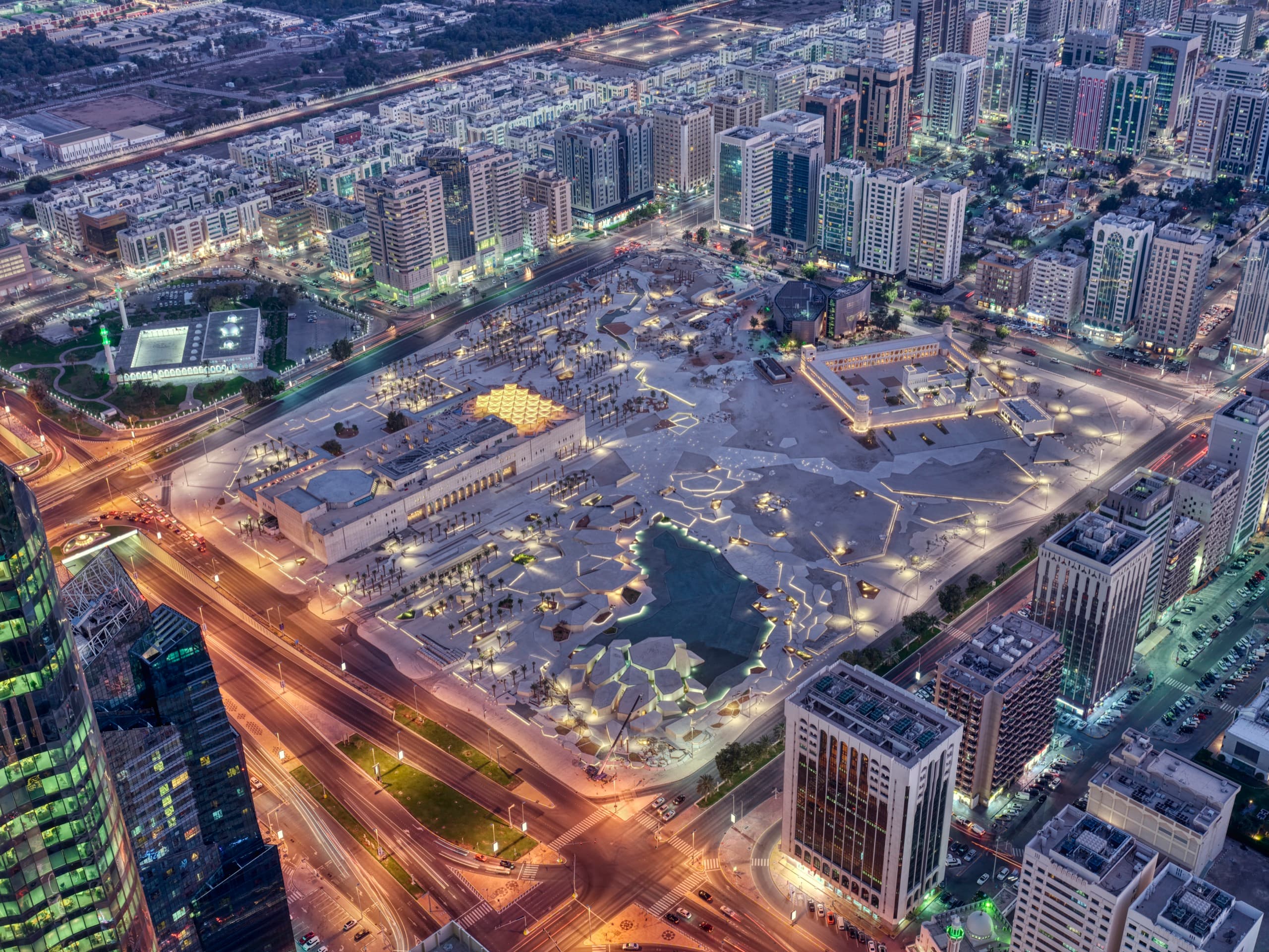 The city centre from the air at night, the old fort of Qasr Al Hosn lit among the towers