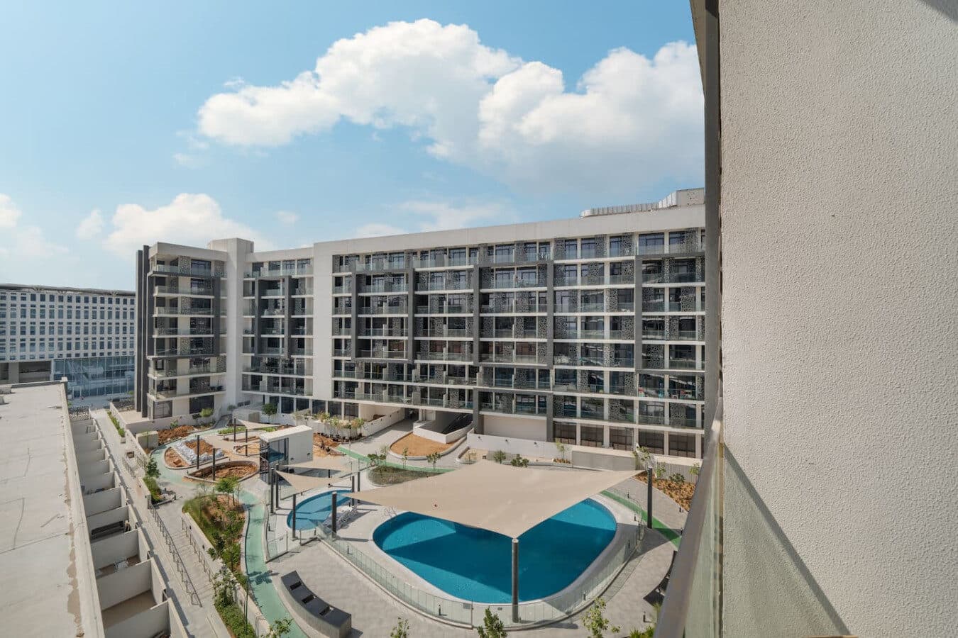 The Gate's outdoor pool from a balcony, the building's wings around it