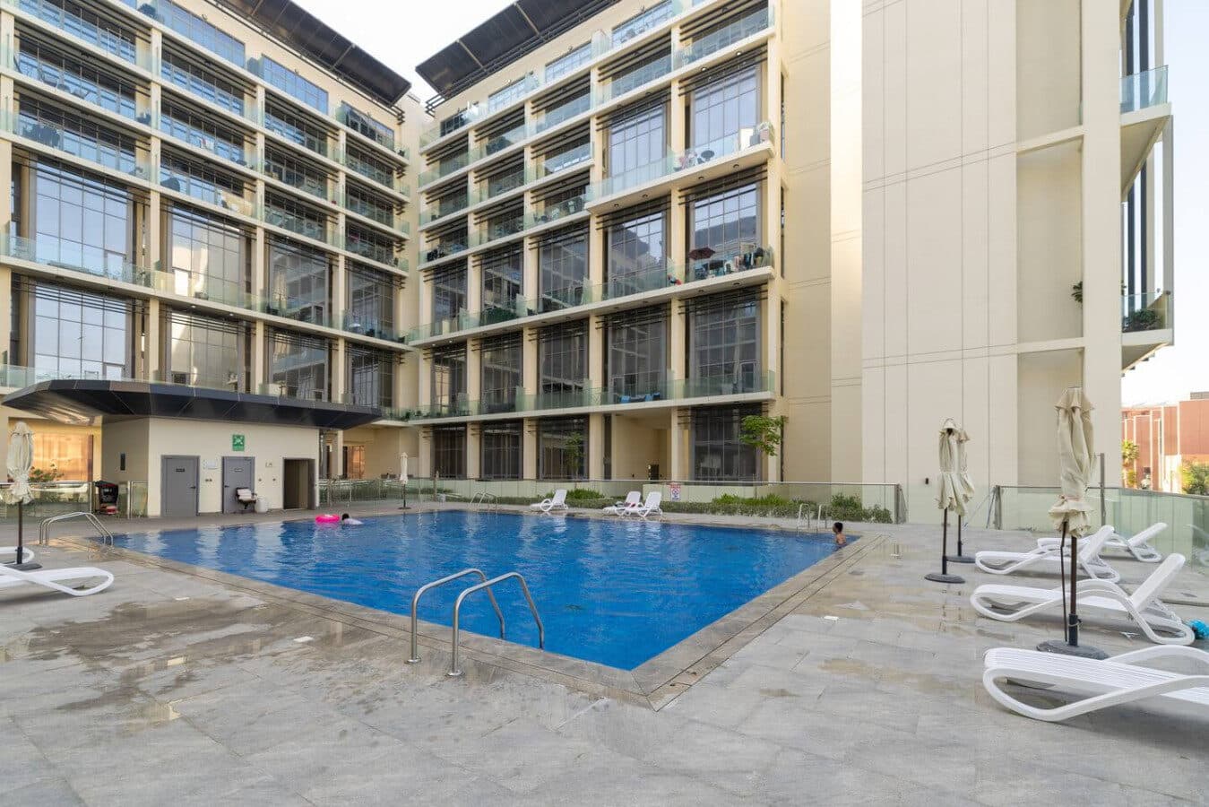 The pool in the Oasis 2 courtyard, framed by the building's balconies