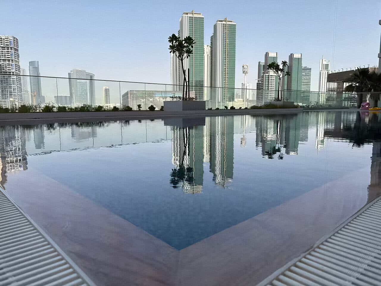 The infinity pool at Al Maryah Vista reflecting the towers across the water