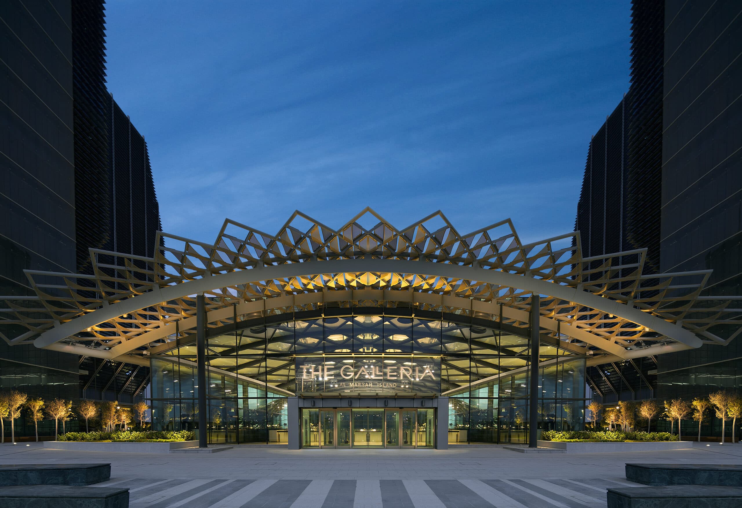 The lit canopy over the entrance to The Galleria at dusk