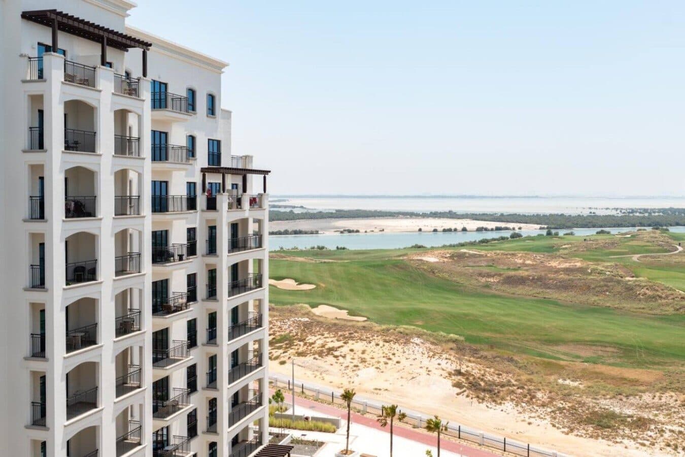 A Yas Golf Collection block beside the Yas Links fairways, the sea beyond