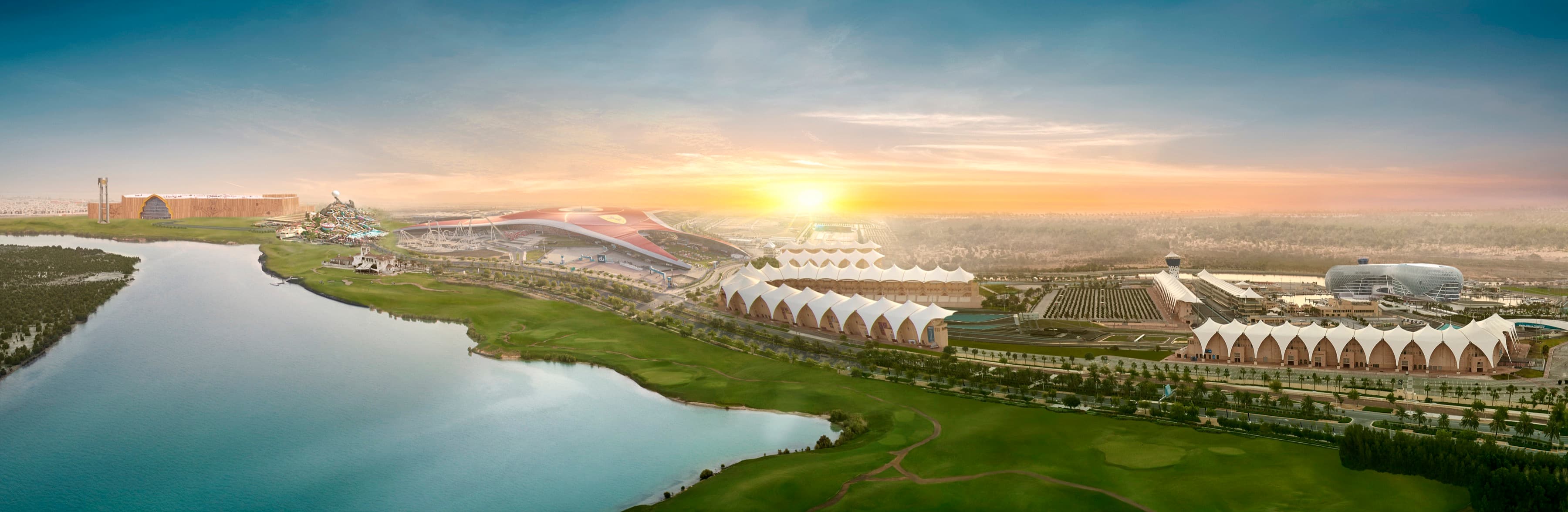 Yas Island from the air at sunrise: the links course and its lake, the circuit's grandstands and the theme parks beyond